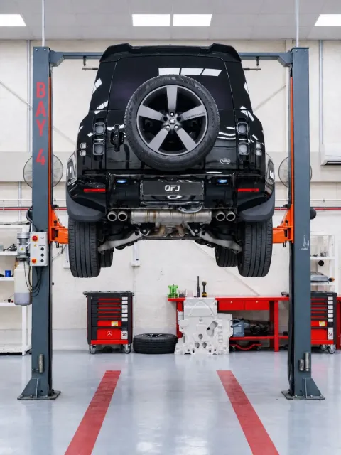 Land Rover Defender on a lift in the OFJ Automotive workshop