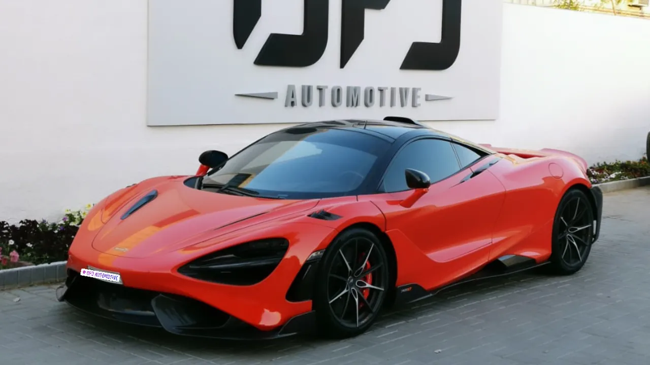 Orange McLaren 765LT in front of the OFJ Automotive sign, Al Quoz, Dubai